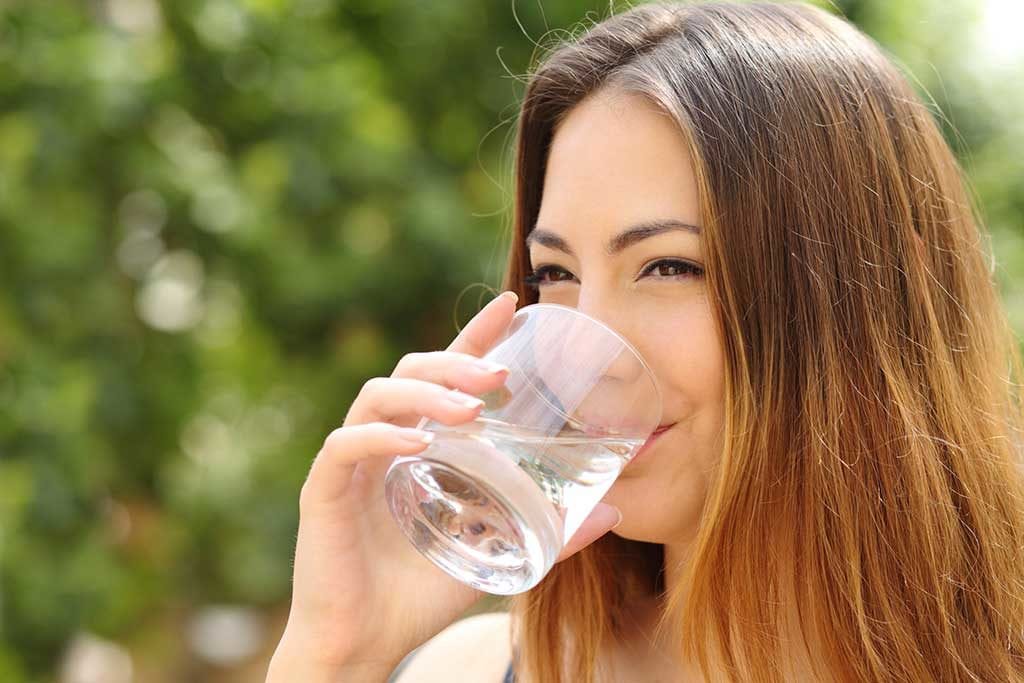 woman drinking clean water from a glass